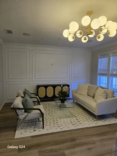 Formal living room with new trim molding, recessed lighting and modern chandelier