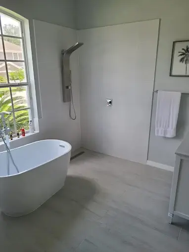 Master bathroom with freestanding tub beside a tiled walk-in shower