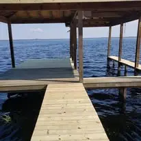 Rebuilt lakefront boat dock with fresh pressure-treated wood decking