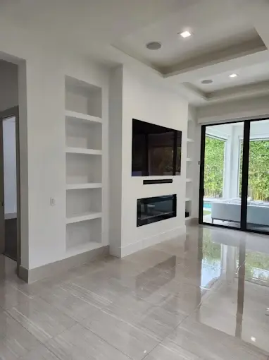 Living room built-ins with fireplace, floating shelves and large-format tile flooring