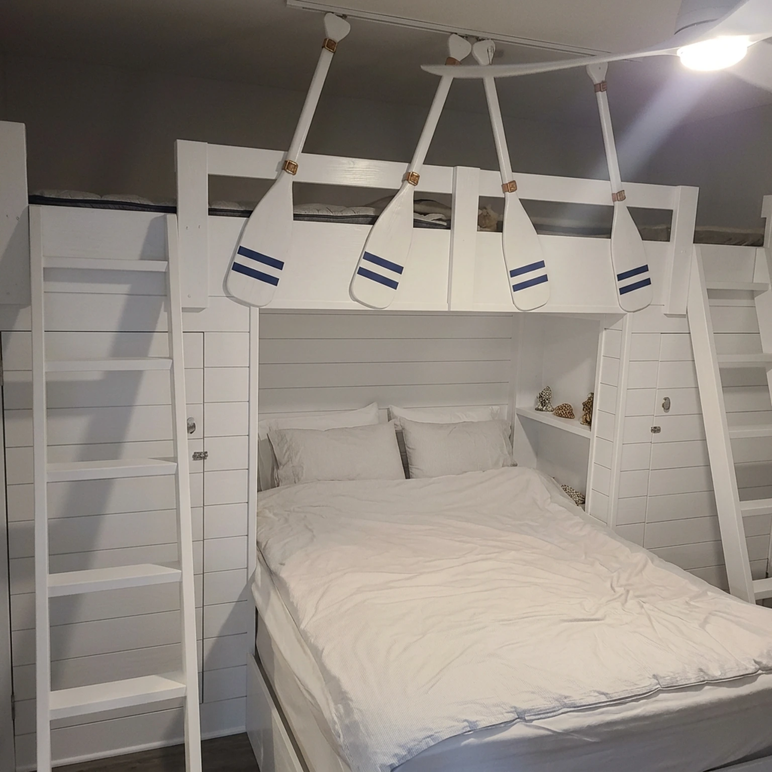 Custom-built white bunk bed with ladder framed and finished on site
