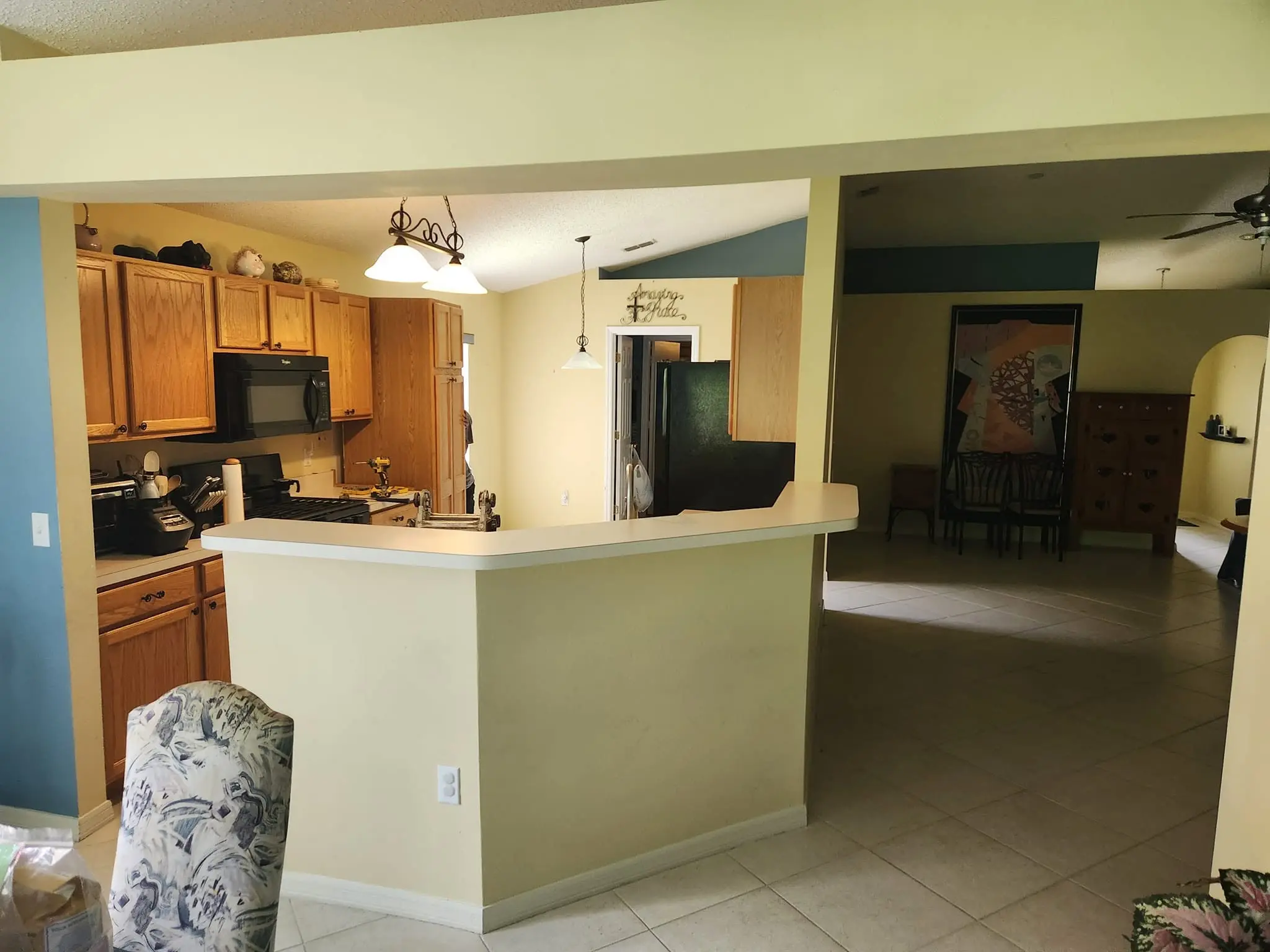 Dated oak kitchen with pass-through window before a Top Cat Construction remodel